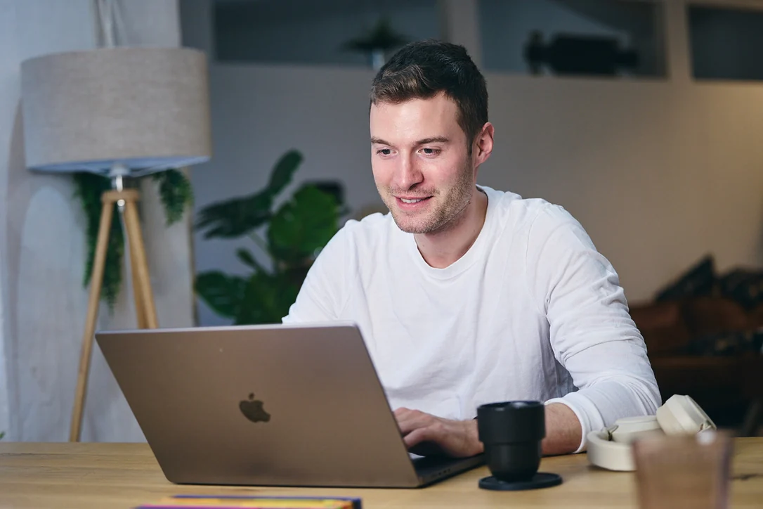 Mediacharge team member working on a laptop